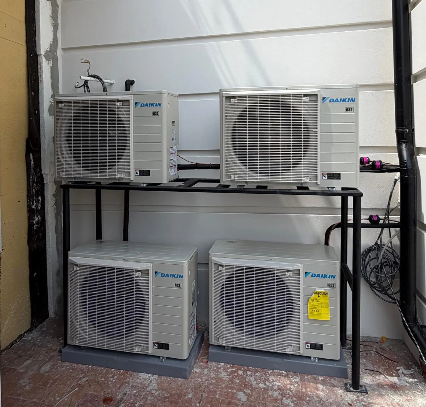 A multi-zone ductless installation with units on a raised rack and at ground level