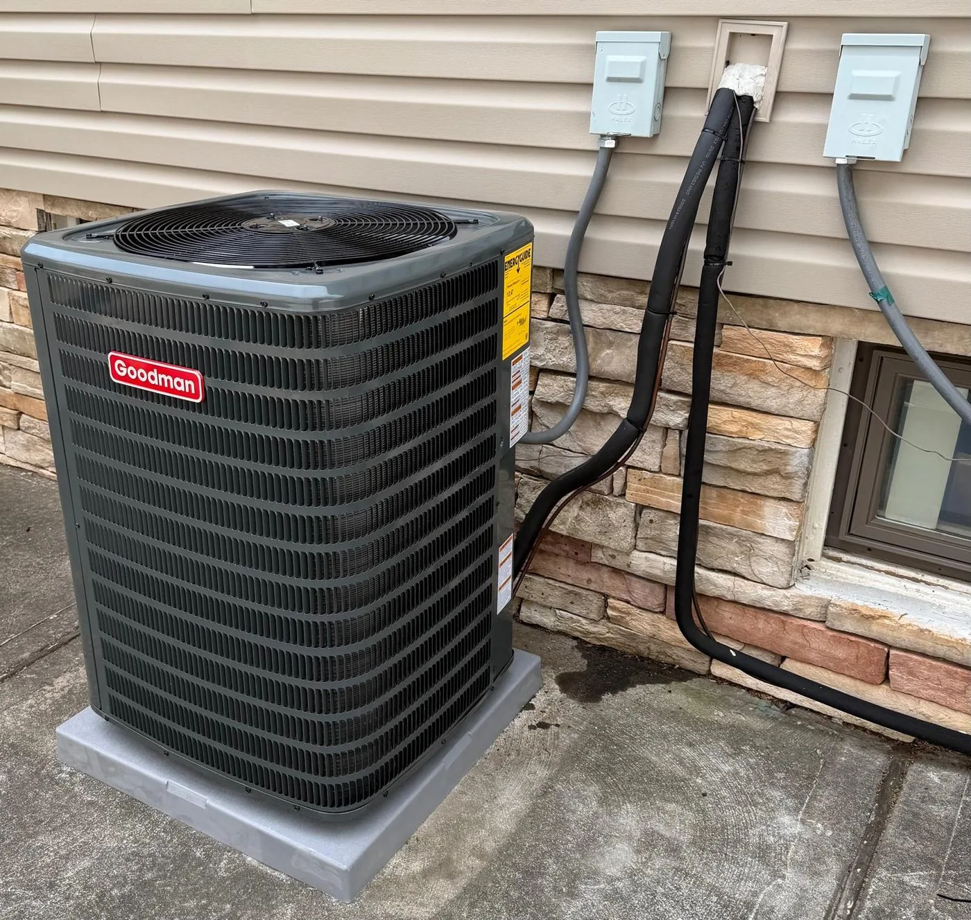 A new condenser on a composite pad with line set and two electrical disconnects