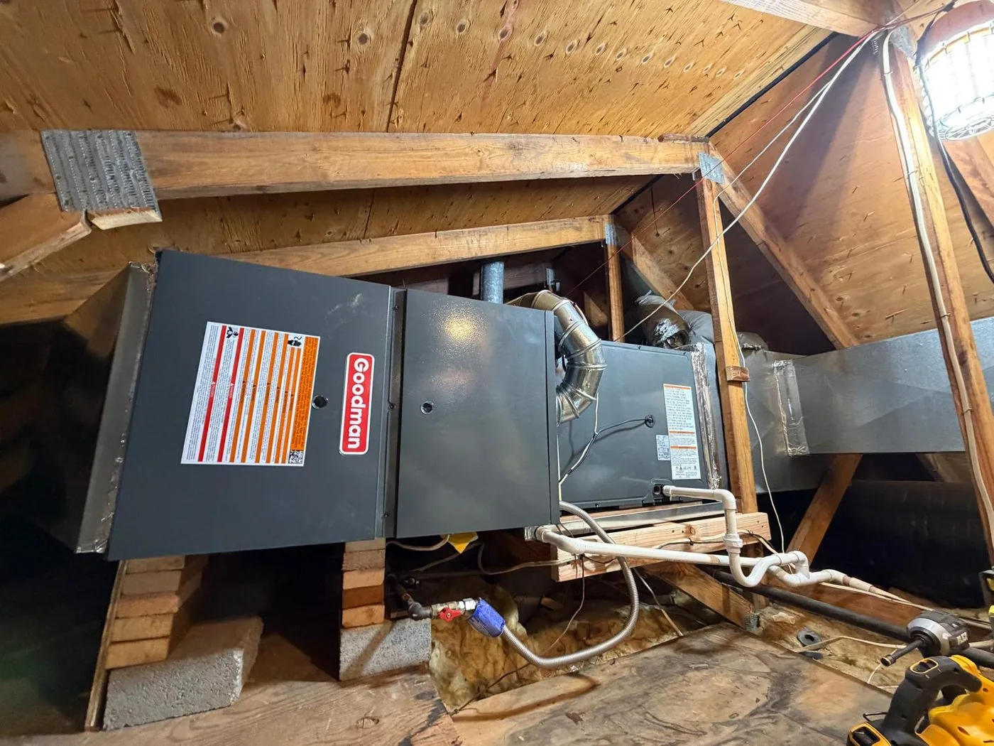 A replacement furnace installed in an attic with new venting